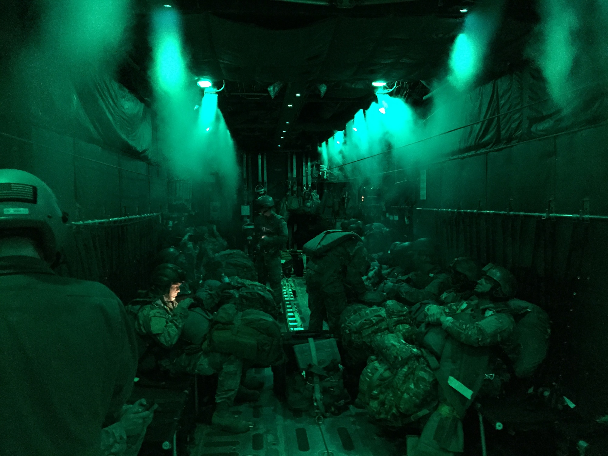 U.S. Army paratroopers standby while approaching their designated drop zone aboard a C-130H Hercules aircraft assigned to the 103rd Airlift Wing Oct. 8, 2014, in the skies above Hunter Army Airfield, Ga. This is the second opportunity for the Flying Yankees to successfully aid in the preparation and execution of paratrooper air drops during joint Army air transportation training missions with their newly-assigned aircraft. (Photo courtesy of Tech. Sgt. Tufic Paone)
