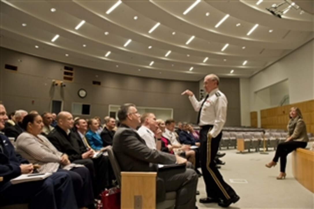 Army Gen. Martin E. Dempsey, chairman of the Joint Chiefs of Staff, and his wife, Deanie, speak at a Capstone course at the National Defense University on Fort Lesley J. McNair in Washington, D.C., Oct., 24, 2014. The six-week course, which aims to make students more effective in planning and employing U.S. forces in joint and combined operations, is mandatory for senior military officers.