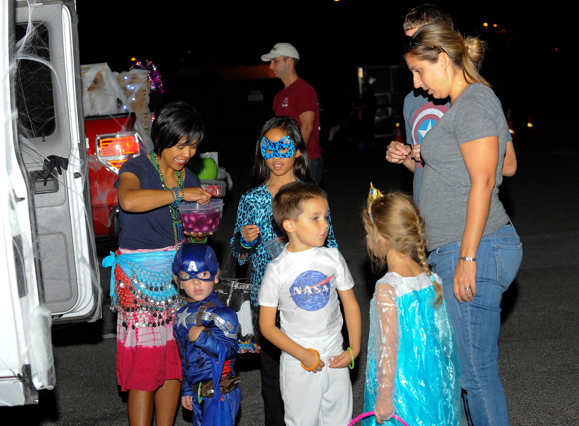Jane Leon passes out homemade eyeballs during a Trunk-N-Treat event on Hurlburt Field, Fla., Oct. 17, 2014. The 1st Special Operations Maintenance Group hosted the event to allow children to trick-or-treat from different vehicles that were covered with creepy, fun decorations. (U.S. Air Force photo/Airman 1st Class Andrea Posey)