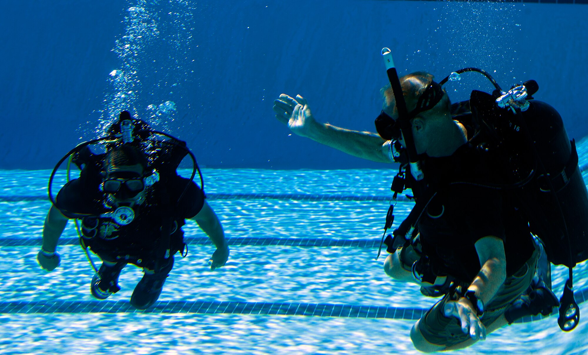 Michael Gray, right, 24th Special Operations Wing water operations instructor, tests Johnnie Yellock’s, left, retired Staff Sgt. and 23rd Special Tactics Squadron combat controller, ability to move through water during SCUBA-Pool Emergency Procedures training on Hurlburt Field, Fla. Oct. 21, 2014. “Johnny’s situation does not allow the use of swim fins,” said Gray. “He pretty much follows the same guidelines used for paraplegics.” (U.S. Air Force photo/Senior Airman Kentavist P. Brackin)