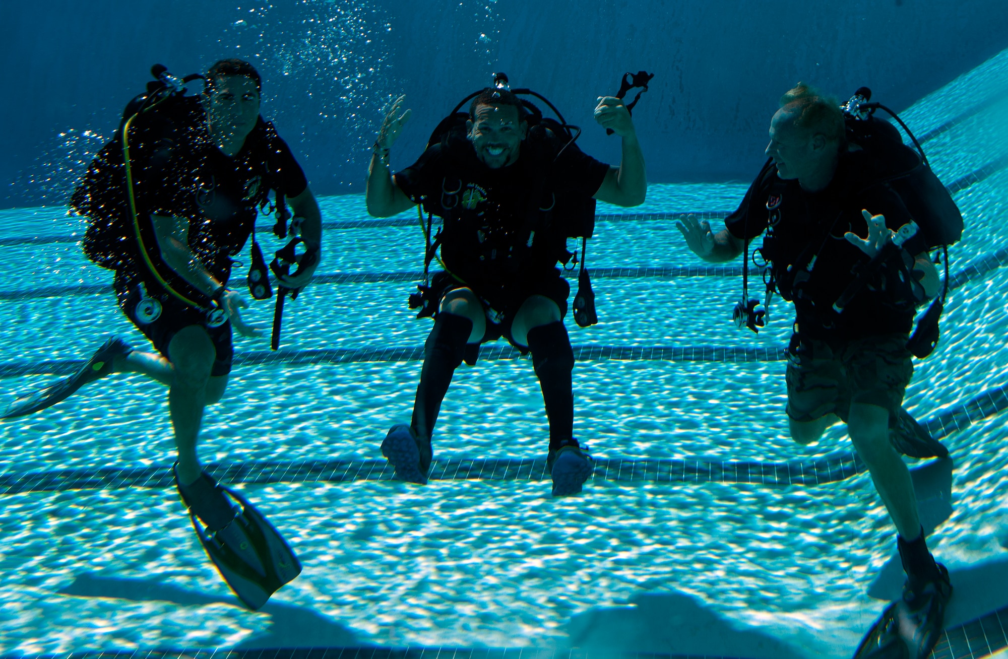Johnnie Yellock, middle, retired Staff Sgt. and 23rd Special Tactics Squadron combat controller, takes a group photo with his instructors during SCUBA-Pool Emergency Procedures training on Hurlburt Field, Fla. Oct. 21, 2014. “I’ve always given credit to my family and faith for my resiliency, but more than that it’s just surrounding yourself with great people,” said Yellock. “If you spend your life surrounding yourself with great people then when times get hard it makes it easier to rely on them.” (U.S. Air Force photo/Senior Airman Kentavist P. Brackin)