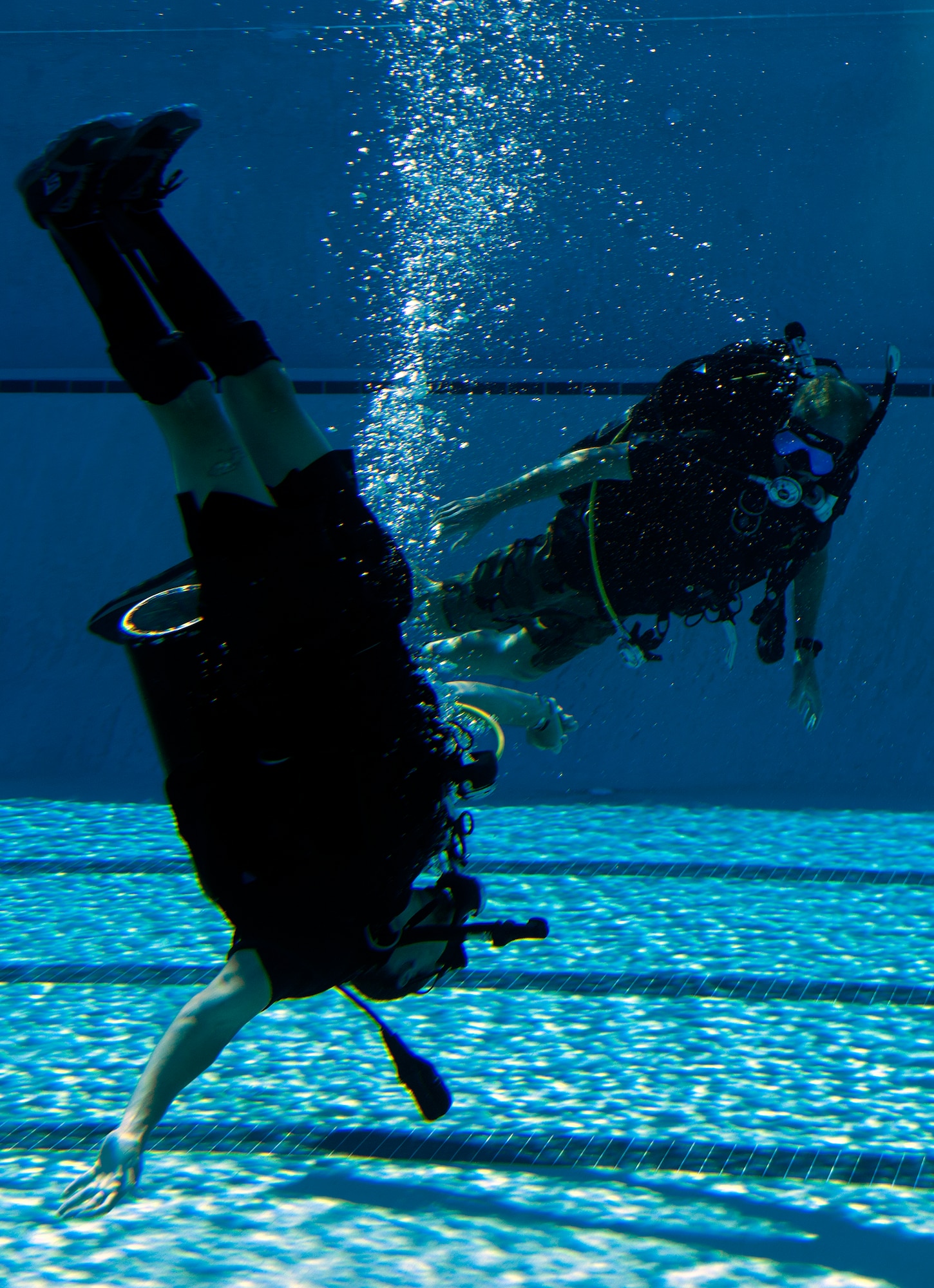 Johnnie Yellock, left, retired Staff Sgt. and 23rd Special Tactics Squadron combat controller, attempts vertical swimming while Michael Gray, right, 24th Special Operations Wing water operations instructor, looks on during SCUBA-Pool Emergency Procedures training on Hurlburt Field, Fla. Oct. 21, 2014. One of challenges Yellock had during the refresher training was maintaining his balance in water without the usual support and propulsion of his legs.(U.S. Air Force photo/Senior Airman Kentavist P. Brackin)


