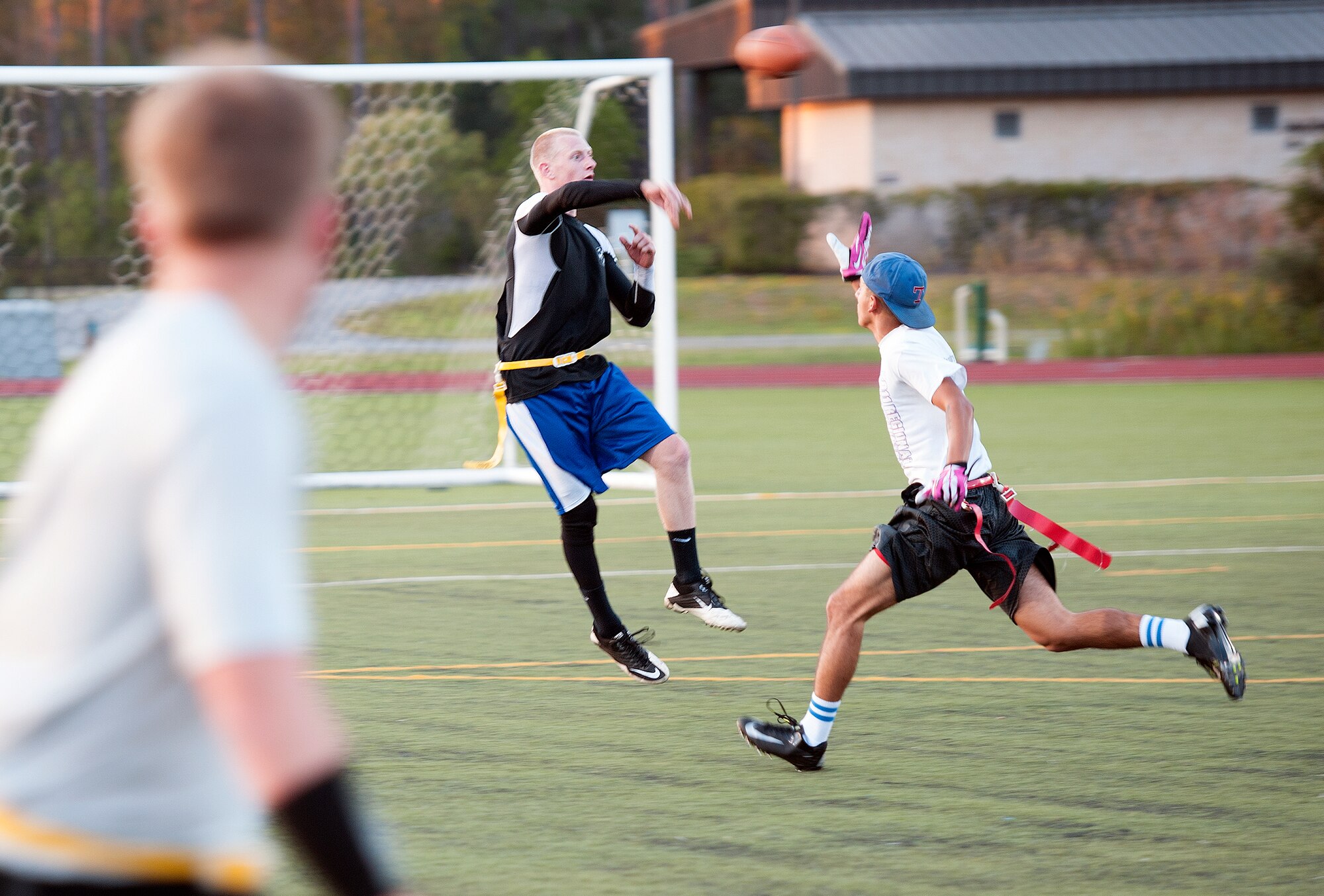 Ellis Parker, 1st Special Operations Maintenance Group quarterback, makes a pass attempt during an intramural flag football game on Hurlburt Field, Fla., Oct. 21, 2014. The 1st SOMXG defeated the 1st Special Operations Force Support Squadron, 30-24. (U.S. Air Force photo/Senior Airman Kentavist P. Brackin)