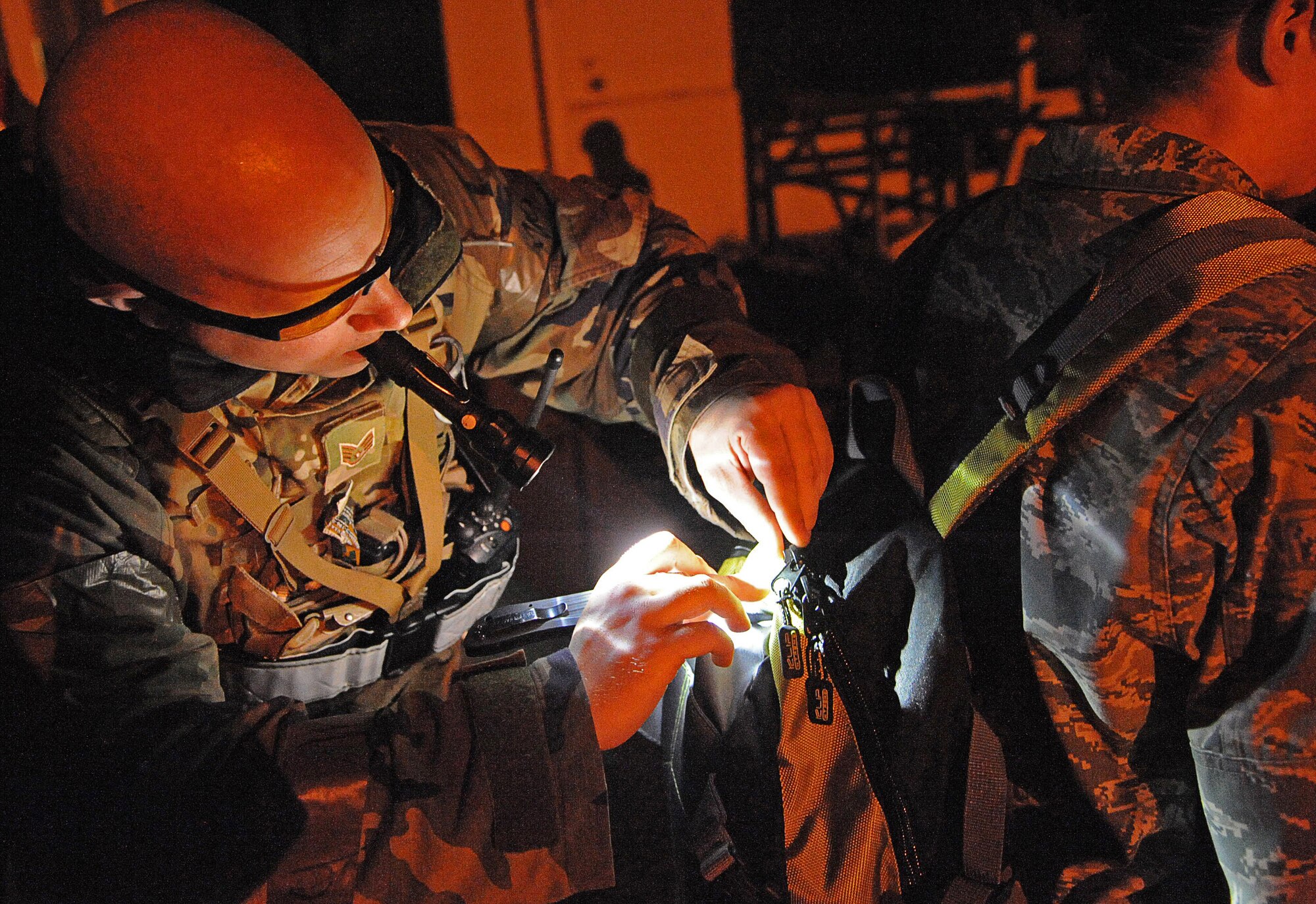Staff Sgt. Christopher Dahmen, 8th Civil Engineer Squadron explosive ordinance disposal team leader, cuts open a backpack with a simulated improvised explosive device inside during Exercise Beverly Midnight 15-1, Oct. 20, 2014. The four-day exercise demonstrated the Wolf Pack's ability to work alongside Republic of Korea air force allies as well as their capability of responding to wartime and armistice threats. (U.S. Air Force photo by Senior Airman Divine Cox/Released) 