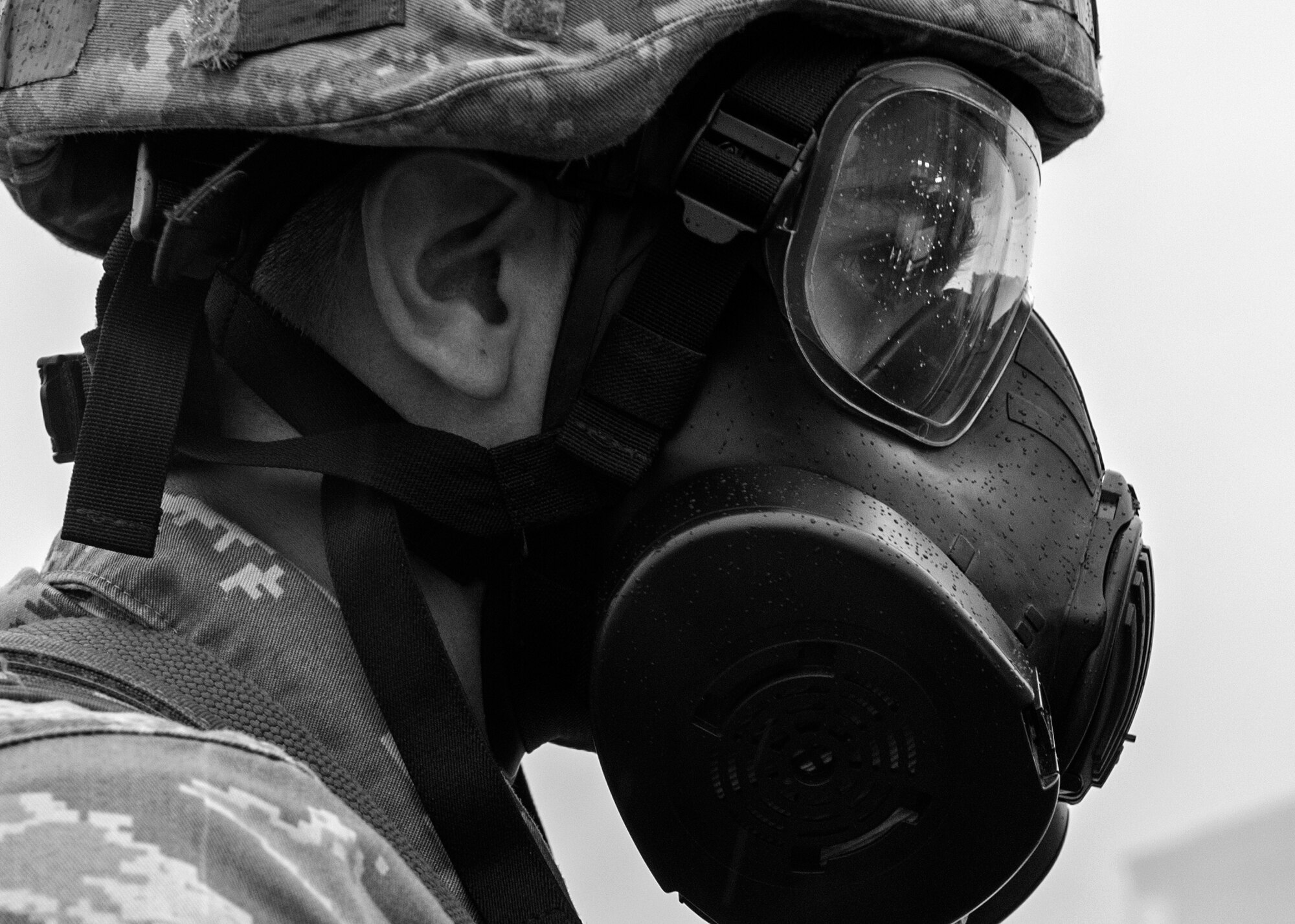 Staff Sgt. Gary Bass, 8th Security Forces Squadron member, stares into a cloud of smoke outside the Kunsan Air Base food court as he prepares to respond to a simulated mass casualty event during Exercise Beverly Midnight 15-1, Oct. 20, 2014. The four-day exercise demonstrated the Wolf Pack's ability to work alongside Republic of Korea air force allies as well as their capability of responding to wartime and armistice threats. (U.S. Air Force photo by Senior Airman Katrina Heikkinen/Released)