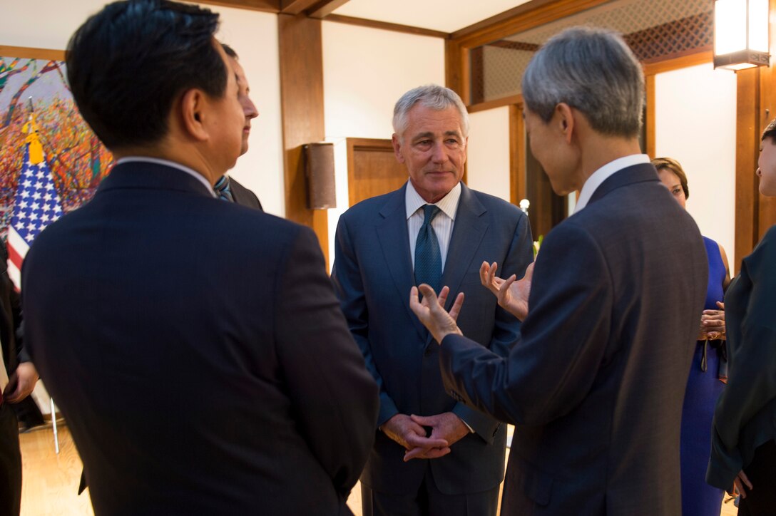 U.S. Defense Secretary Chuck Hagel speaks with South Korean Ambassador to the United States Ahn Ho-Young and other guests following a reception for recently appointed U.S. Ambassador to South Korea Mark Lippert in Washington D.C., Oct. 24, 2014. 