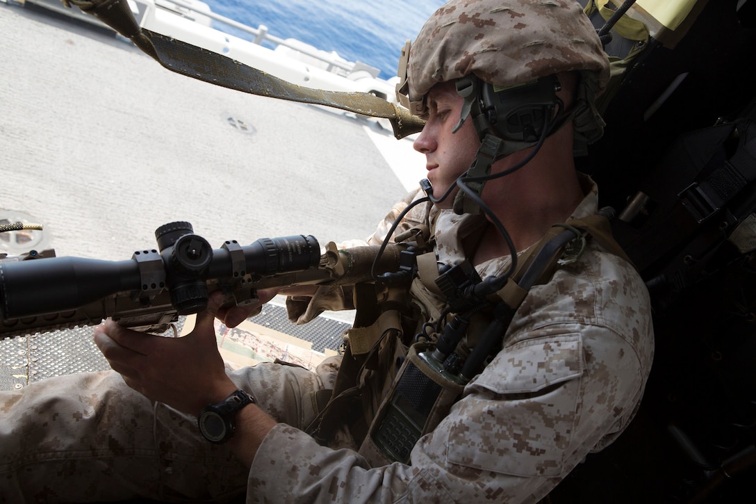Corporal Phillip Lilly II, a chief scout with Scout Sniper Platoon, Battalion Landing Team, 3rd Battalion, 6th Marine Regiment, 24th Marine Expeditionary Unit, prepares his rifle during Amphibious Ready Group/Marine Expeditionary Unit Exercise aboard the USS Iwo Jima, at sea, Sept. 16, 2014. The Marines conducted a Visit, Board, Search and Seizure exercise during Amphibious Ready Group/ Marine Expeditionary Unit Exercise, which spans over the majority of September.