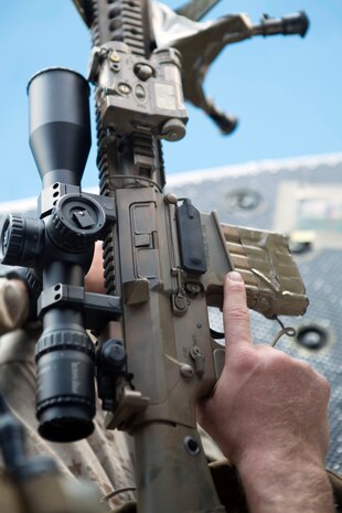 Corporal Phillip Lilly II, a chief scout with Scout Sniper Platoon, Battalion Landing Team, 3rd Battalion, 6th Marine Regiment, 24th Marine Expeditionary Unit, prepares his rifle during Amphibious Ready Group/Marine Expeditionary Unit Exercise, at sea, Sept. 16, 2014. The Marines conducted a Visit, Board, Search and Seizure exercise during Amphibious Ready Group/ Marine Expeditionary Unit Exercise, which spans over the majority of September.