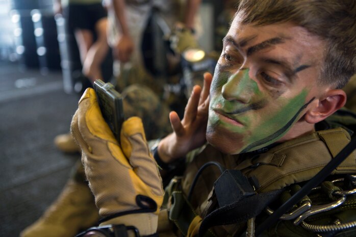 A 24th Marine Expeditionary Unit’s Maritime Raid Force Marine applies face paint during Amphibious Ready Group/Marine Expeditionary Unit Exercise aboard the USS Iwo Jima, at sea, Sept. 11, 2014. The Marines with the MRF conducted a Reconnaissance and Surveillance exercise inserting by air.  