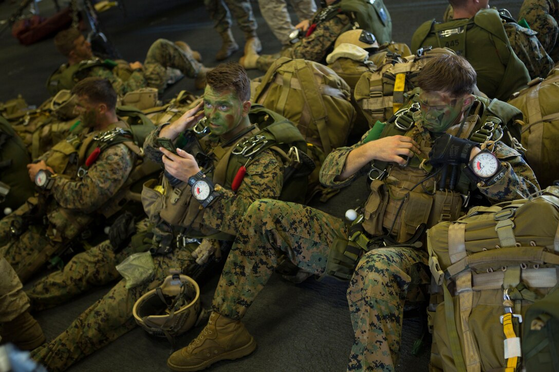 The 24th Marine Expeditionary Unit’s Maritime Raid Force Marines apply face paint during Amphibious Ready Group/Marine Expeditionary Unit Exercise aboard the USS Iwo Jima, at sea, Sept. 11, 2014. The Marines with the MRF conducted a Reconnaissance and Surveillance exercise inserting by air.  