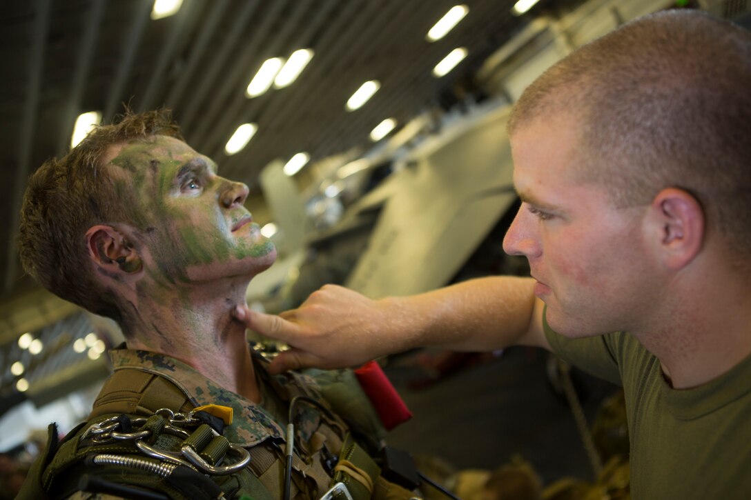A 24th Marine Expeditionary Unit’s Maritime Raid Force Marine applies face paint to a Navy corpsman during Amphibious Ready Group/Marine Expeditionary Unit Exercise aboard the USS Iwo Jima, at sea, Sept. 11, 2014. The Marines with the MRF conducted a Reconnaissance and Surveillance exercise inserting by air.  