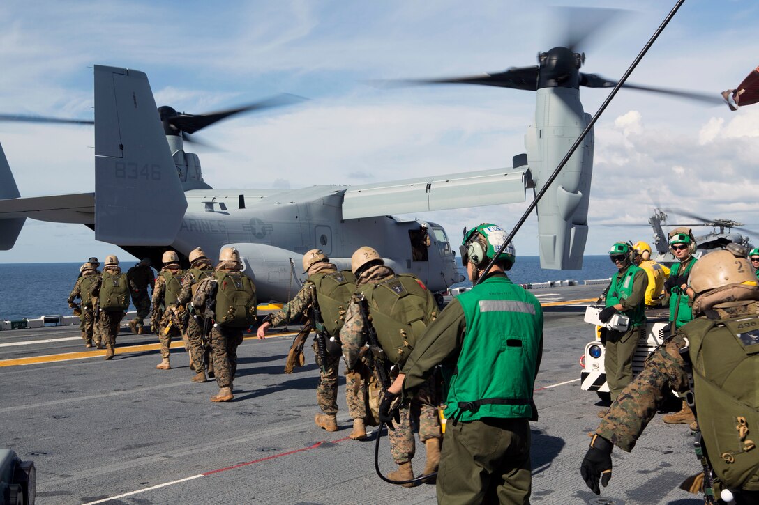 The 24th Marine Expeditionary Unit’s Maritime Raid Force Marines board an MV-22B Osprey from Marine Medium Tiltrotor Squadron 365 (Reinforced), 24th MEU, during Amphibious Ready Group/Marine Expeditionary Unit Exercise aboard the USS Iwo Jima, at sea, Sept. 11, 2014. The Marines with the MRF conducted a Reconnaissance and Surveillance exercise inserting by air.  