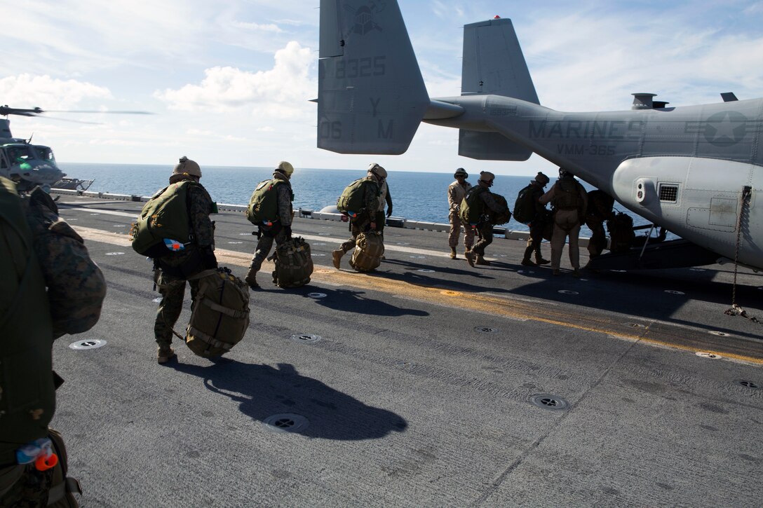 The 24th Marine Expeditionary Unit’s Maritime Raid Force Marines board an MV-22B Osprey from Marine Medium Tiltrotor Squadron 365 (Reinforced), 24th MEU, during Amphibious Ready Group/Marine Expeditionary Unit Exercise aboard the USS Iwo Jima, at sea, Sept. 11, 2014. The Marines with the MRF conducted a Reconnaissance and Surveillance exercise inserting by air.  