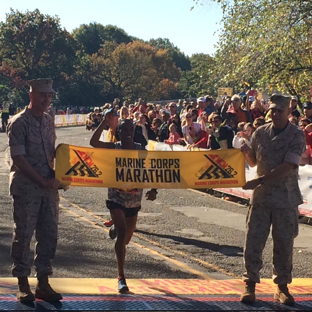 Army Spec. Samuel Kosgei as he crosses the finish line to win the 39th Marine Corps Marathon. 