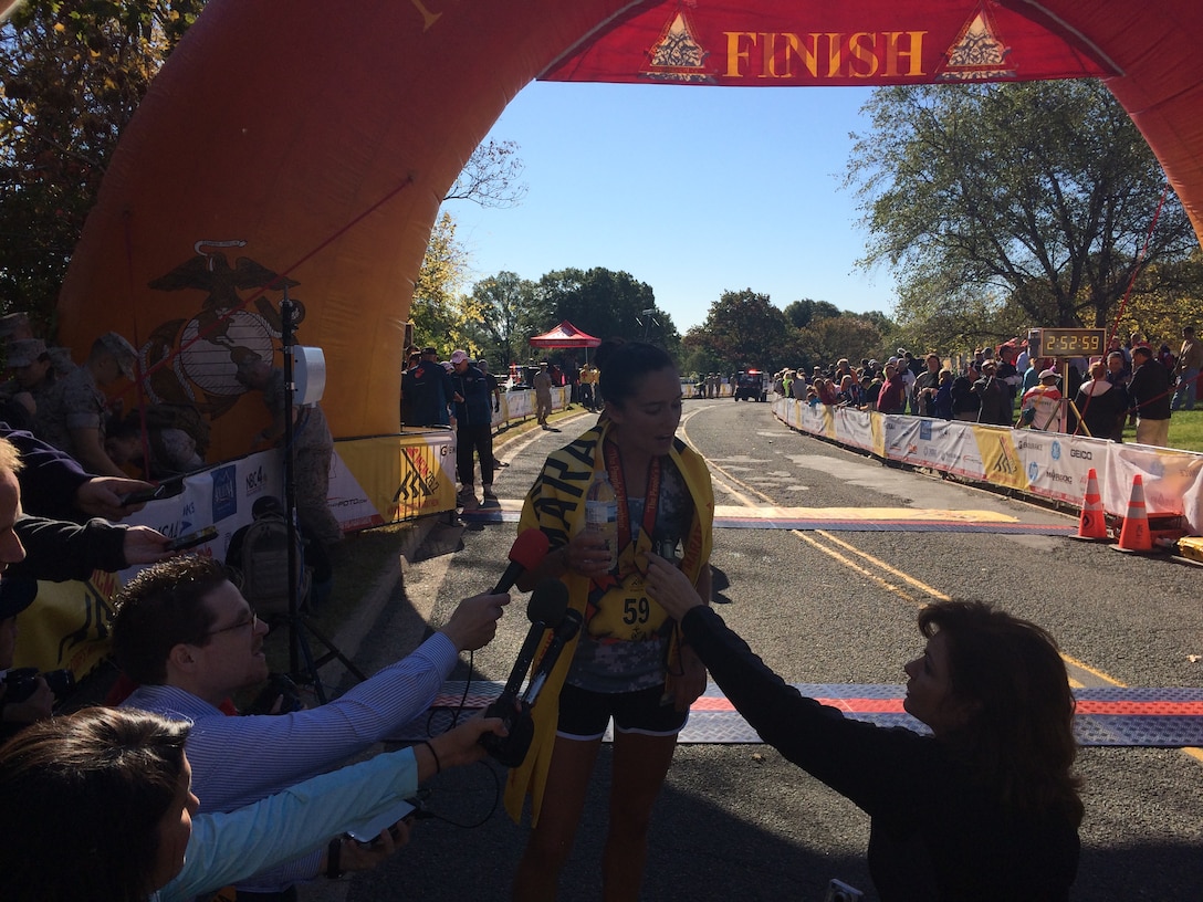 Army Capt. Meghan Curran after crossing the finish line, winning the 39th Marine Corps Marathon Women's Title.