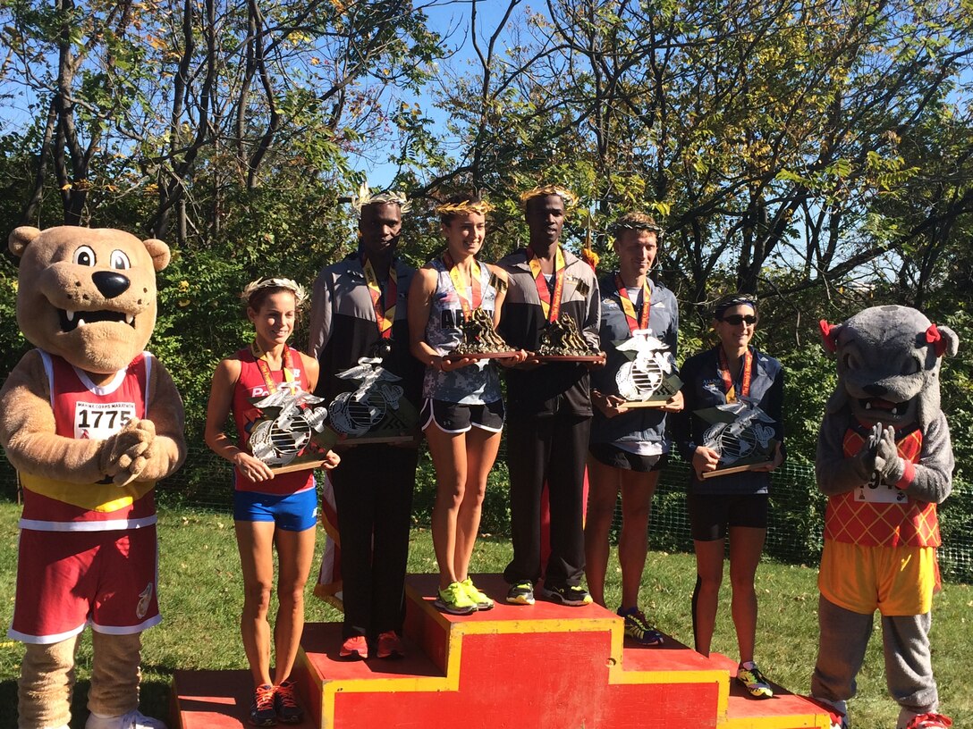 The top finishers of the 39th Marine Corps Marathon. Armed Forces athletes took five of the six spots on the podium, with Army Capt Meghan Curran and Army Spec. Samuel Kosgei winning the Women's and Men's Division.
From left to right:

Ms. Lindsey Wilkens (2nd Female); Army Spec. Laban Sialo (2nd Male); Army Capt. Meghan Curran (1st Female); Army Spec. Samuel Kosgei (1st Male); Navy Petty Officer 2nd Class Justin Turner and Navy Lieut. Gina Slaby