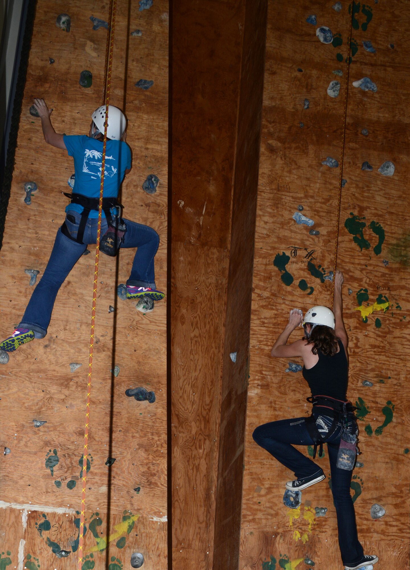 Two spouses from the 1st Special Operations Squadron scale the climbing wall at the 320th Special Tactics Squadron Oct. 3, 2014 at Kadena Air Base, Japan.   The 353rd Special Operations Group hosted Spouses Day which gave spouse an opportunity tour the aircraft along with participating in the squadrons’ hands-on exhibits.  (U.S. Air Force photo by Tech. Sgt. Kristine Dreyer)