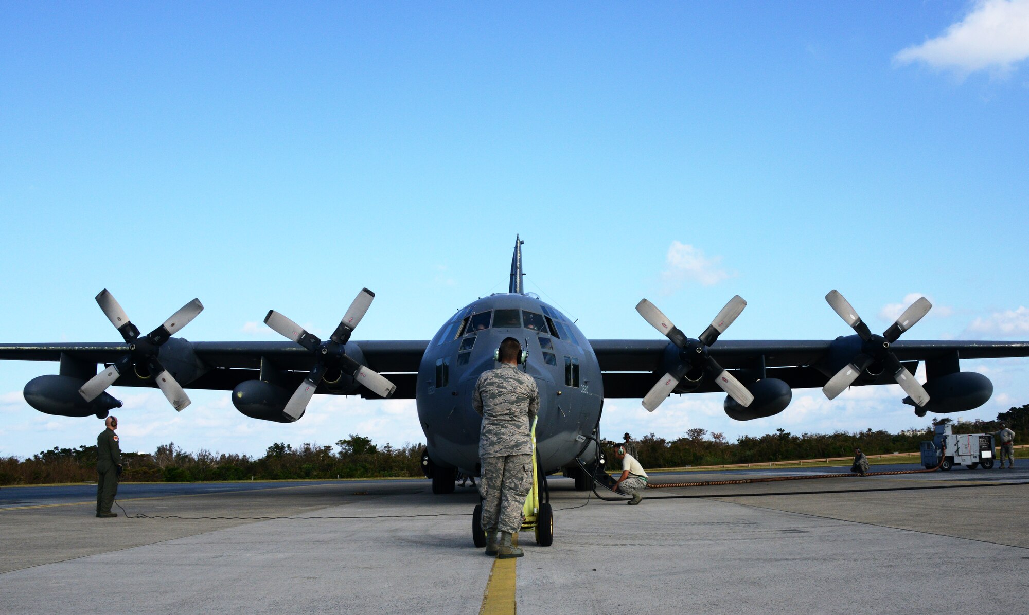 A MC-130P Combat Shadow crew and maintainers prepare to start engines before conducting a 4-ship formation flight Oct. 16, 2014 at Kadena Air Base, Japan.  The formation flight marks the beginning of the retirement for the Combat Shadow in the Pacific, as the unit transitions to the MC-130J Commando II.  (U.S. Air Force photo by Tech. Sgt. Kristine Dreyer)