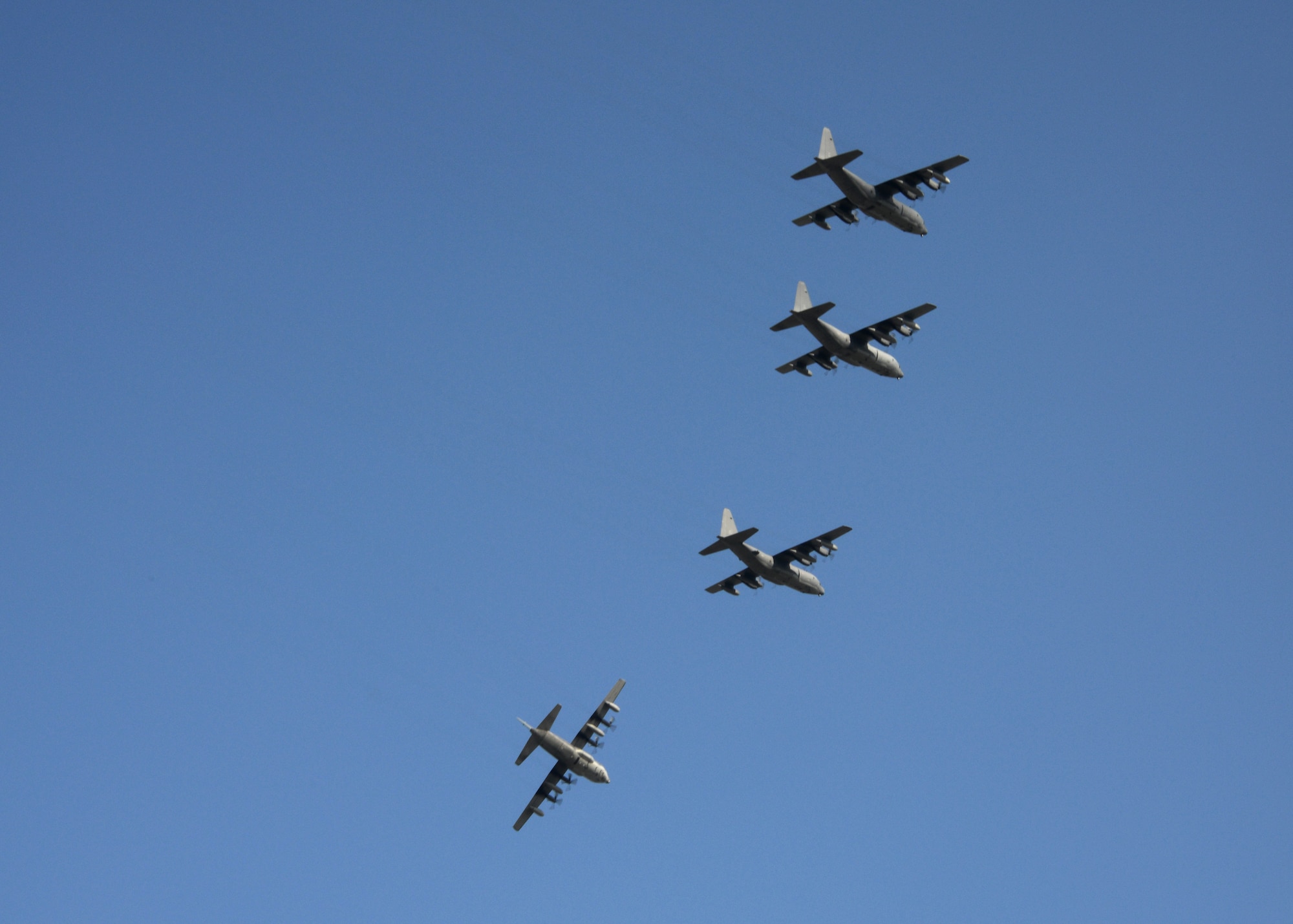 Four MC-130P Combat Shadow aircraft perform an overhead break maneuver Oct. 16, 2014 at Kadena Air Base, Japan during a formation flight.  The 17th Special Operations Squadron used the formation flight to pay tribute to the Combat Shadow as it begins retirement.  The unit will transition to the MC-130J Commando II over the next year. (U.S. Air Force photo by Tech. Sgt. Kristine Dreyer)