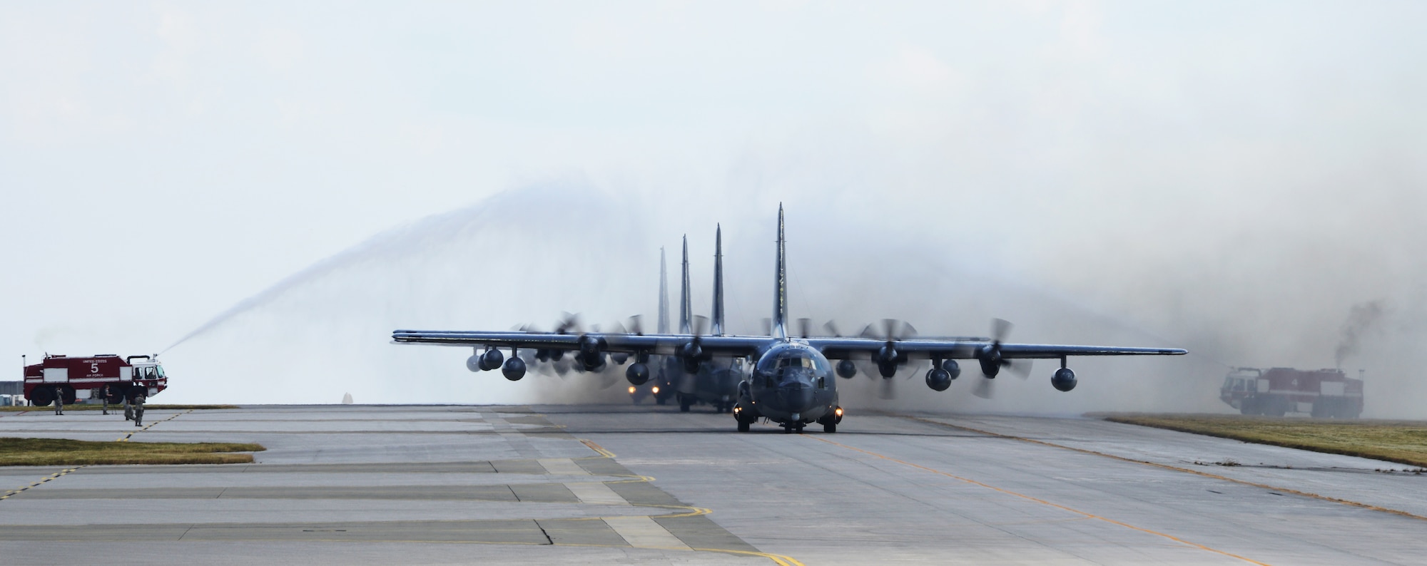 Four MC-130P Combat Shadows taxi through the water arch after completing a final 4-ship formation flight Oct. 16, 2014.  Over the next year, the MC-130P Combat Shadow aircraft in the Pacific will be replaced with the MC-130J Commando II.  (U.S. Air Force photo by Tech. Sgt. Kristine Dreyer)