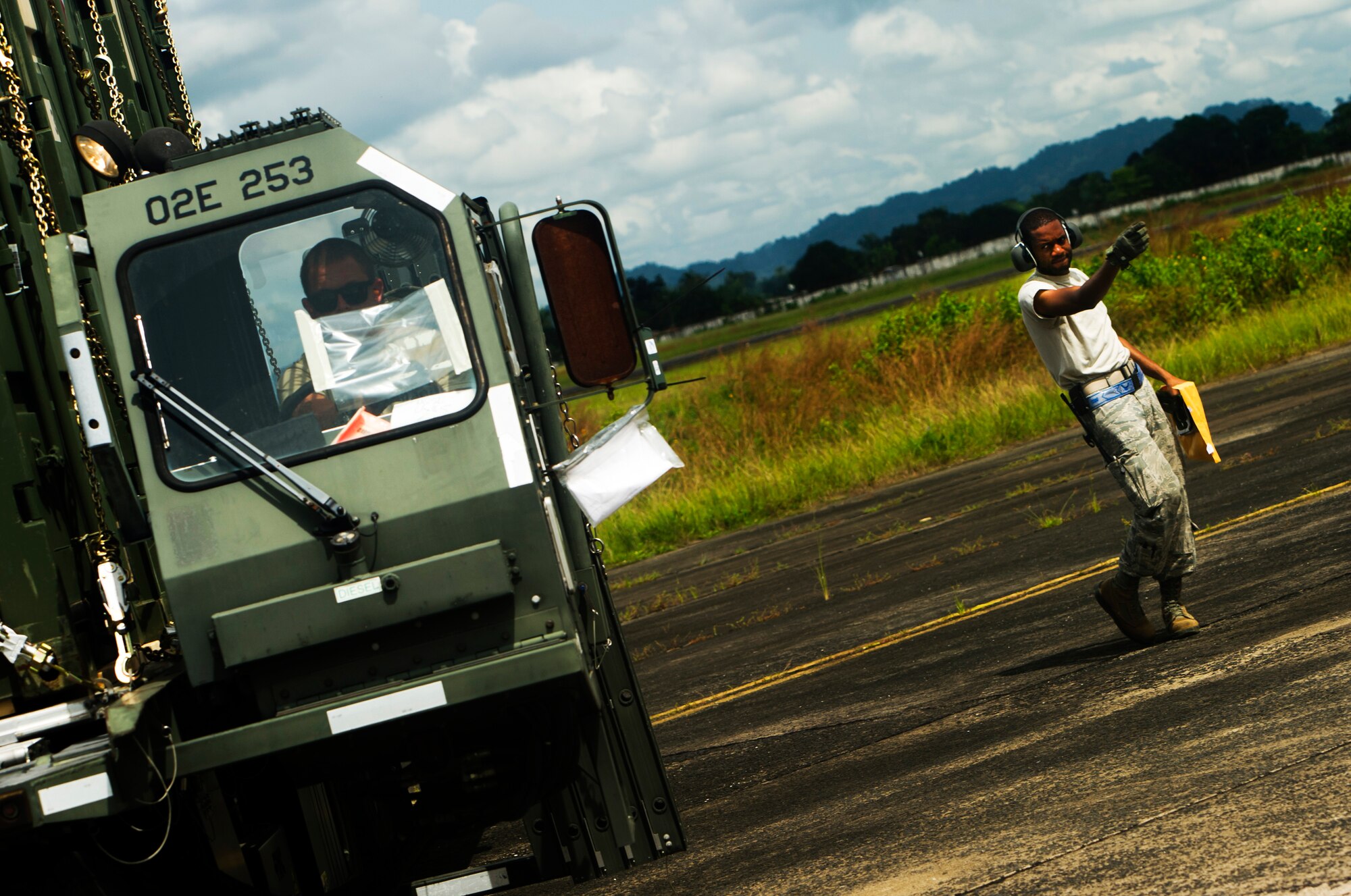 ROBERTS INTERNATIONAL AIRPORT, Republic of Liberia - U.S. Air Force Senior Airmen Kavion Bryan, an aerial porter part of the Joint Task Force-Port Opening team of the 621st Contingency Response Wing assigned to Joint Base McGuire-Dix-Lakehurst, N.J., directs forklifts at the flightline during Operation UNITED ASSISTANCE here, October 19, 2014. The 621 CRW is working in support of the USAID-led interagency team and the international community to provide effective and efficient delivery of assistance to the Government of Liberia to end the EVD outbreak. (U.S. Air Force photo/Staff Sgt. Gustavo Gonzalez/RELEASED)