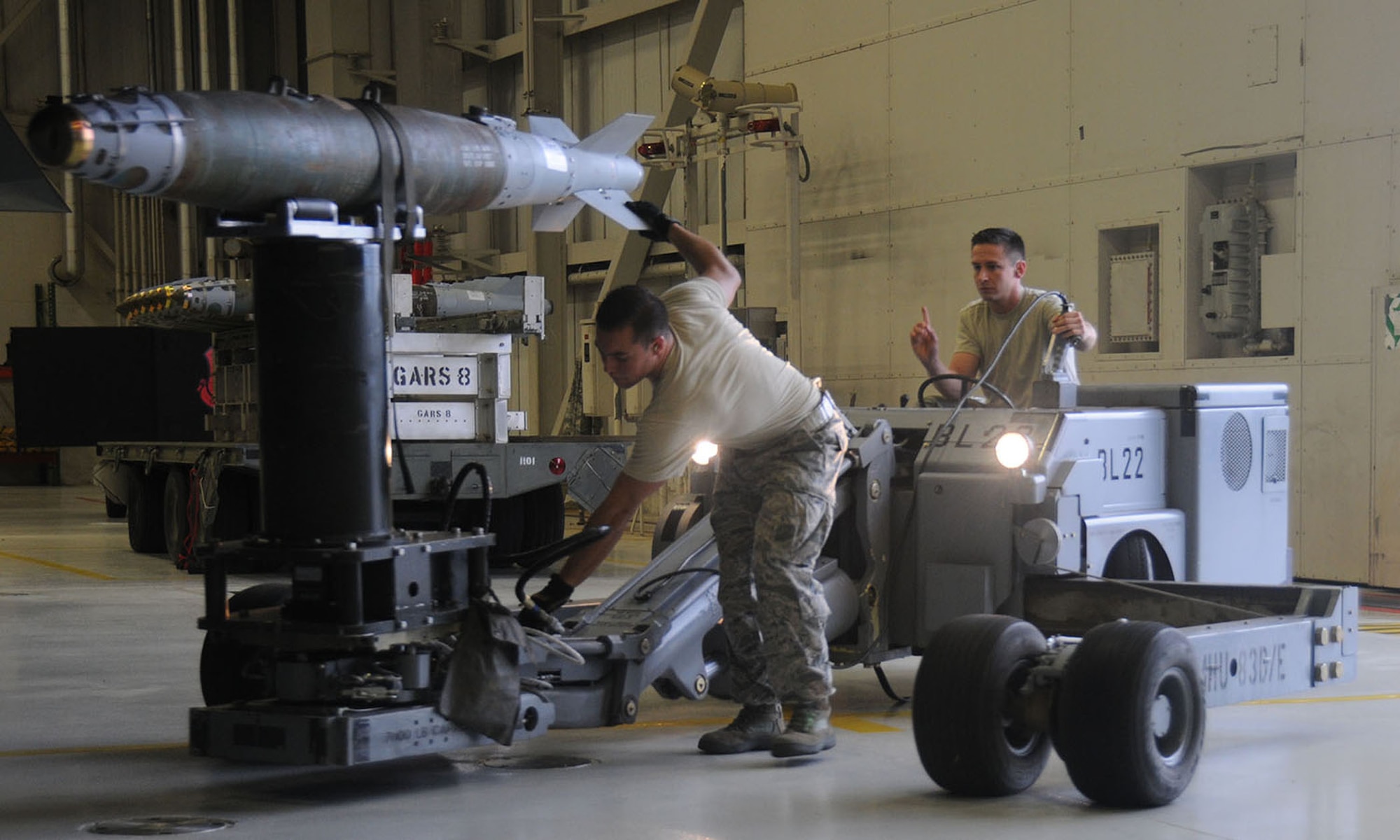Staff Sgt. Jeremie Key and Jake Smith, both weapons loaders with the 131st Maintenance Group, usher one of 15 conventional bombs to the B-2 Spirit aircraft  during the October 2014 Global Strike Challenge at Whiteman Air Force Base, Missouri. Key, Smith and other participants were evaluated on their functional area understanding through knowledge tests, but then had to display that knowledge during the evaluation the following day.  (U.S. Air National Guard photo by Senior Airman Nathan Dampf/RELEASED)