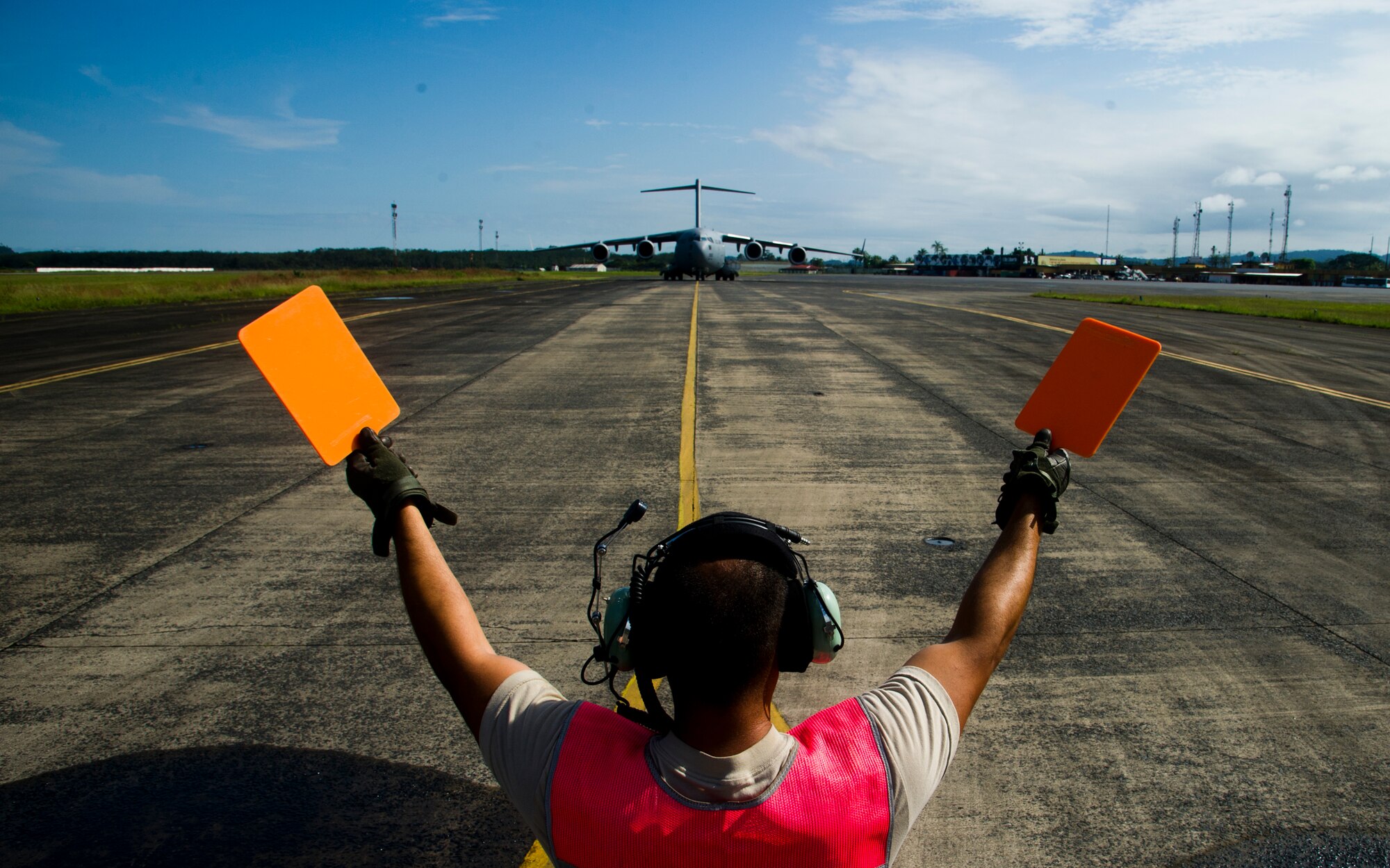 ROBERTS INTERNATIONAL AIRPORT, Republic of Liberia - U.S. Air Force Staff Sgt. Jose Arroyo, an aircraft maintainer part of the Joint Task Force-Port Opening team of the 621st Contingency Response Wing assigned to Joint Base McGuire-Dix-Lakehurst, N.J., marshals in a Globemaster III C-17 during Operation UNITED ASSISTANCE here, October 20, 2014. The 621 CRW is working in support of the USAID-led interagency team and the international community to provide effective and efficient delivery of assistance to the Government of Liberia to end the EVD outbreak. (U.S. Air Force photo/Staff Sgt. Gustavo Gonzalez/RELEASED)