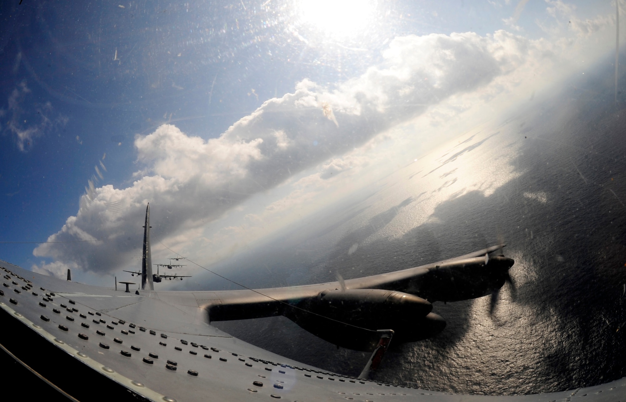 Four MC-130P Combat Shadow aircraft from the 17th Special Operations Squadron conduct a 4-ship formation off the coast of Okinawa, Japan, Oct. 16, 2014. The MC-130P conducts single or multi-ship infiltration, exfiltration and resupply of special operations forces.  Retiring and being replaced by the MC-130J Commando II, the flight marked the last time the Combat Shadow will conduct a four-ship formation at Kadena. (U.S. Air Force photo by Airman 1st Class Keith James)