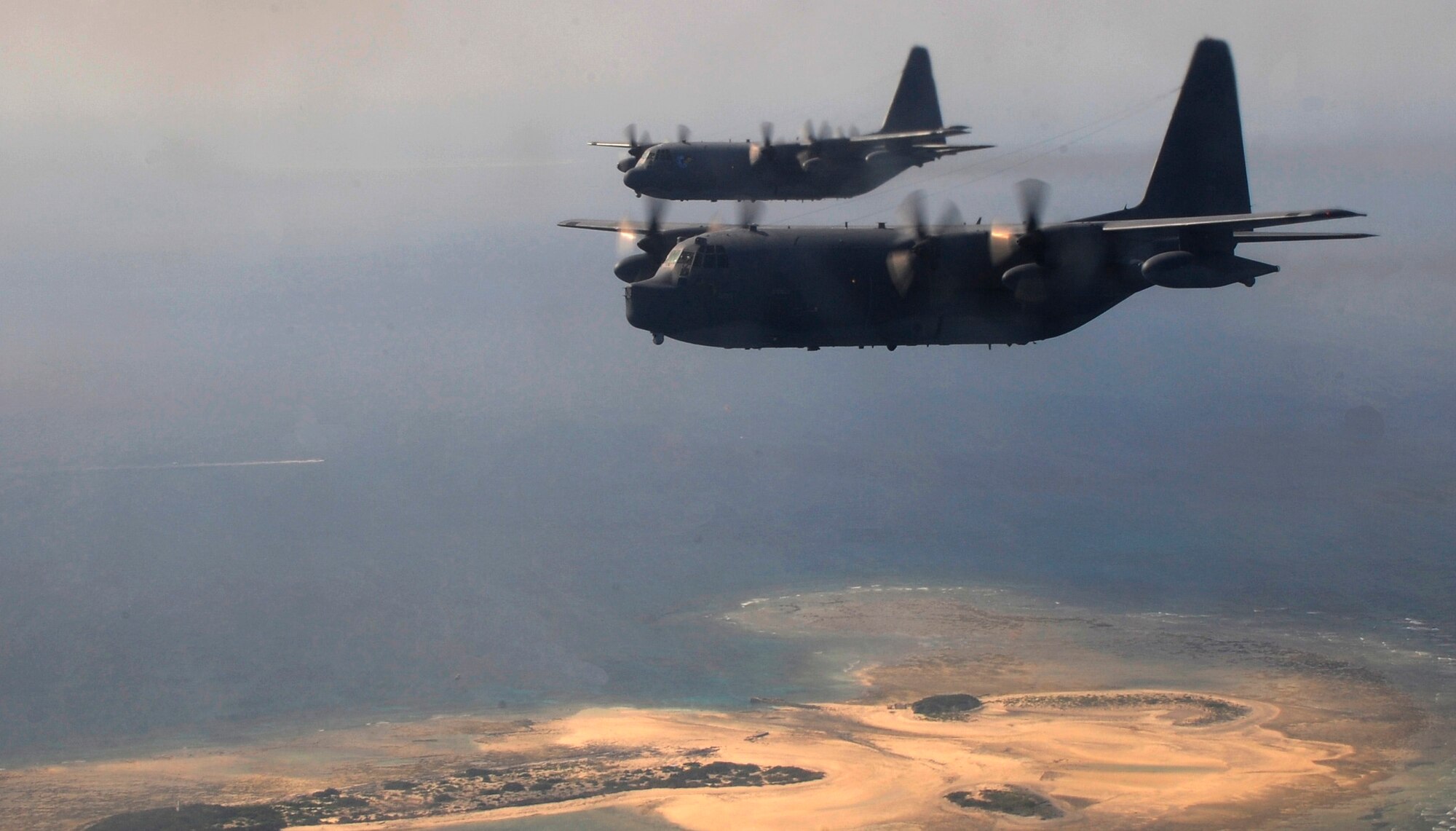 Two MC-130P Combat Shadows assigned to the 17th Special Operations Squadron fly off the coast of Okinawa, Japan, Oct. 16, 2014. The MC-130P conducts single or multi-ship infiltration, exfiltration and resupply of special operations forces.  (U.S. Air Force photo by Airman 1st Class Keith James)