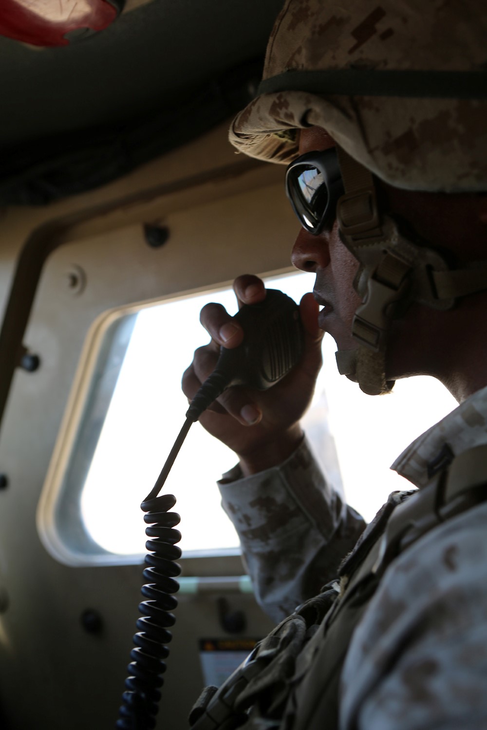 Sgt. Brandon Lesau, an assistant convoy commander with Combat Logistics Battalion 11, 11th Marine Expeditionary Unit (MEU), from South San Francisco, California, communicates with other vehicle commanders during convoy training, Oct. 22. The 11th MEU is deployed with the Makin Island Amphibious Ready Group (ARG) as a theater reserve and crisis response force throughout U.S. Central Command and the U.S. 5th Fleet area of responsibility. (U.S. Marine Corps photo by Sgt. Melissa Wenger/ Released)