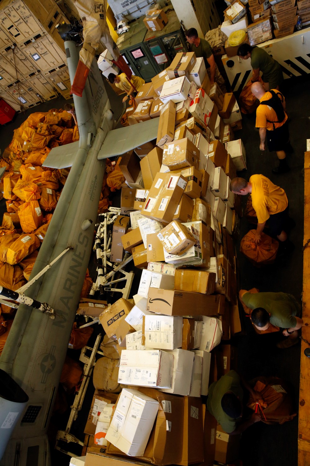 Marines and Sailors deployed with the amphibious transport dock ship USS San Diego (LPD 22) sort mail in the ship’s hangar bay during a replenishment-at-sea, Oct. 23. The 11th MEU is embarked with the Makin Island Amphibious Ready Group and deployed to maintain regional security in the U.S. 5th Fleet area of responsibility. (U.S. Marine Corps photo by Cpl. Jonathan R. Waldman/Released)