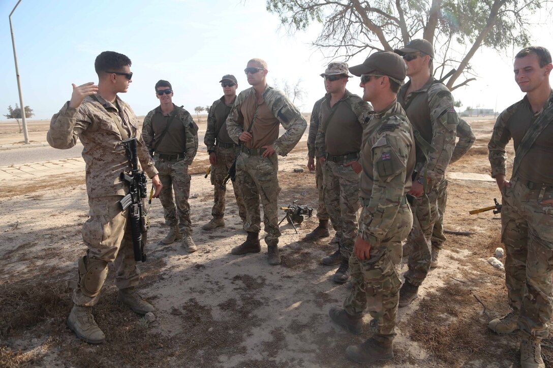 Cpl. Erik Grohmann, a team leader with Fox Company, Battalion Landing Team 2nd Battalion, 1st Marines, 11th Marine Expeditionary Unit (MEU), shares best practices for ground tactics with British Royal Marines during Exercise Cougar Voyage 15. Cougar Voyage is an exercise aimed to strengthen proficiencies, promote interoperability and increase military-to-military relationships to support long-term regional security in the U.S. 5th Fleet area of responsibility. (U.S. Marine Corps photos by Cpl. Demetrius Morgan/ Released)  