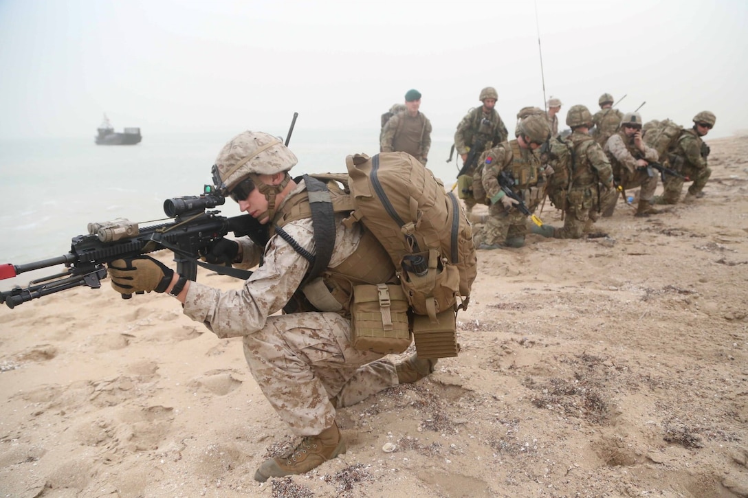 Cpl. Jordan Tompkins, a rifleman with Fox Company, Battalion Landing Team 2nd Battalion, 1st Marines, 11th Marine Expeditionary Unit (MEU), along with designated communication specialists embedded with B Company of the British Royal Marines, practice establishing a security parameter during Exercise Cougar Voyage 15. Cougar Voyage is an exercise aimed to strengthen proficiencies, promote interoperability and increase military-to-military relationships to support long-term regional security in the U.S. 5th Fleet area of responsibility. (U.S. Marine Corps photos by Cpl. Demetrius Morgan/Released)
