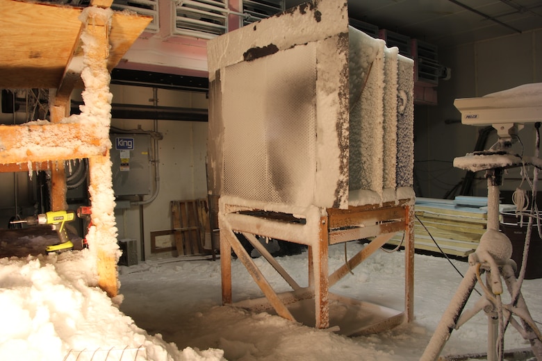 In ERDC-CRREL's Materiel Evaluation Facility (MEF), which has snow-making, freezing-rain, and sleet-making capabilities, researchers evaluate the shedding ability of a mechanical louver system in a variety of snow and sleet conditions.