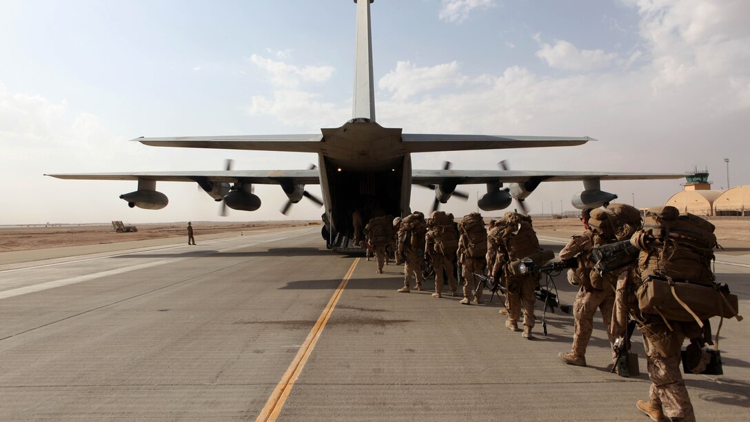 Marines and sailors with Marine Expeditionary Brigade – Afghanistan load onto a KC-130 aircraft on the Camp Bastion flightline, Oct. 27, 2014. The Marine Corps ended its mission in Helmand province, Afghanistan, the day prior and all Marines, sailors and service members from the United Kingdom withdrew from southwestern Afghanistan.