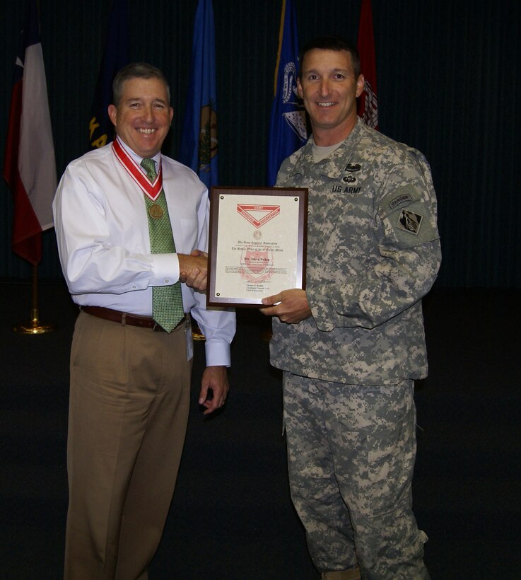 Tulsa District Commander, Col. Richard A. Pratt, presents the Bronze De Fleury medal to Stephen L. Nolen, chief of Natural Resources and Recreation Branch. Nolen has provided 30 years of outstanding service to the U.S. Army Corps of Engineers.