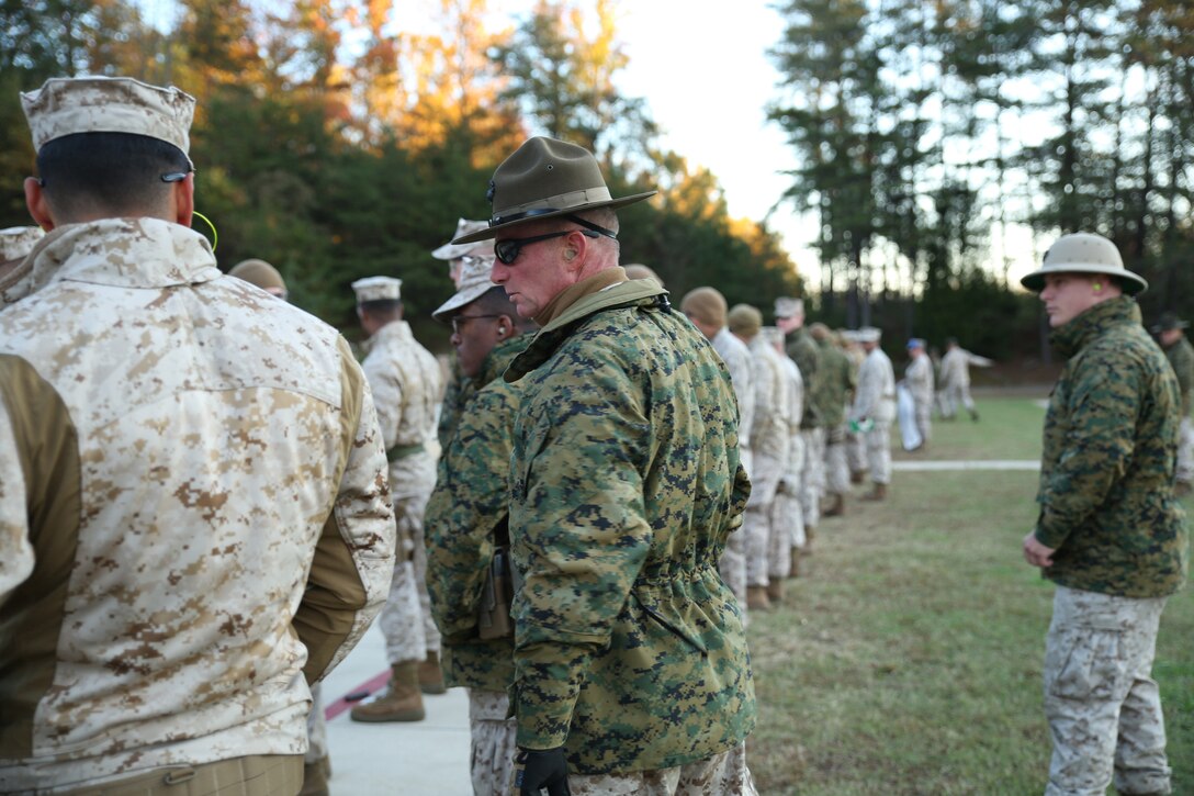 Gunnery Sgt. Daniel Eppler (center), an instructor with the Marine Corps Reserve Marksmanship Training Unit, oversees Reserve Marines in their preparation time during the combat pistol program pre-qualification at Combat Marksmanship Coaches Course at the Marksmanship Training Unit, Weapons Training Battalion in Quantico, Va., Oct. 24, 2014. This particular CMC course was staffed entirely by Reserve Marines from the Marine Corps Reserve Shooting Team, who are the top competitive shooters in the Marine Corps Reserve.