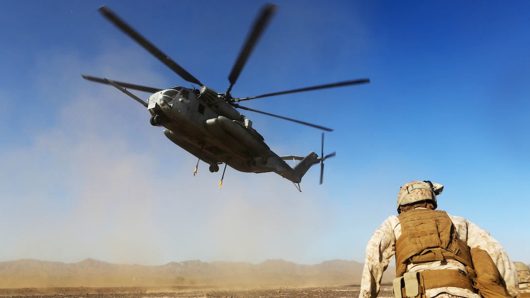 Lance Cpl. Christopher Gauntt, a landing support specialist with Combat Logistics Battalion 13, prepares to connect simulated cargo to a CH-53E Super Stallion with Marine Heavy Helicopter Squadron 462 aboard Marine Corps Air Station Yuma, Ariz., Oct. 23. The training helped the Marines experience the effects of the aircraft while trying to attach the cargo.