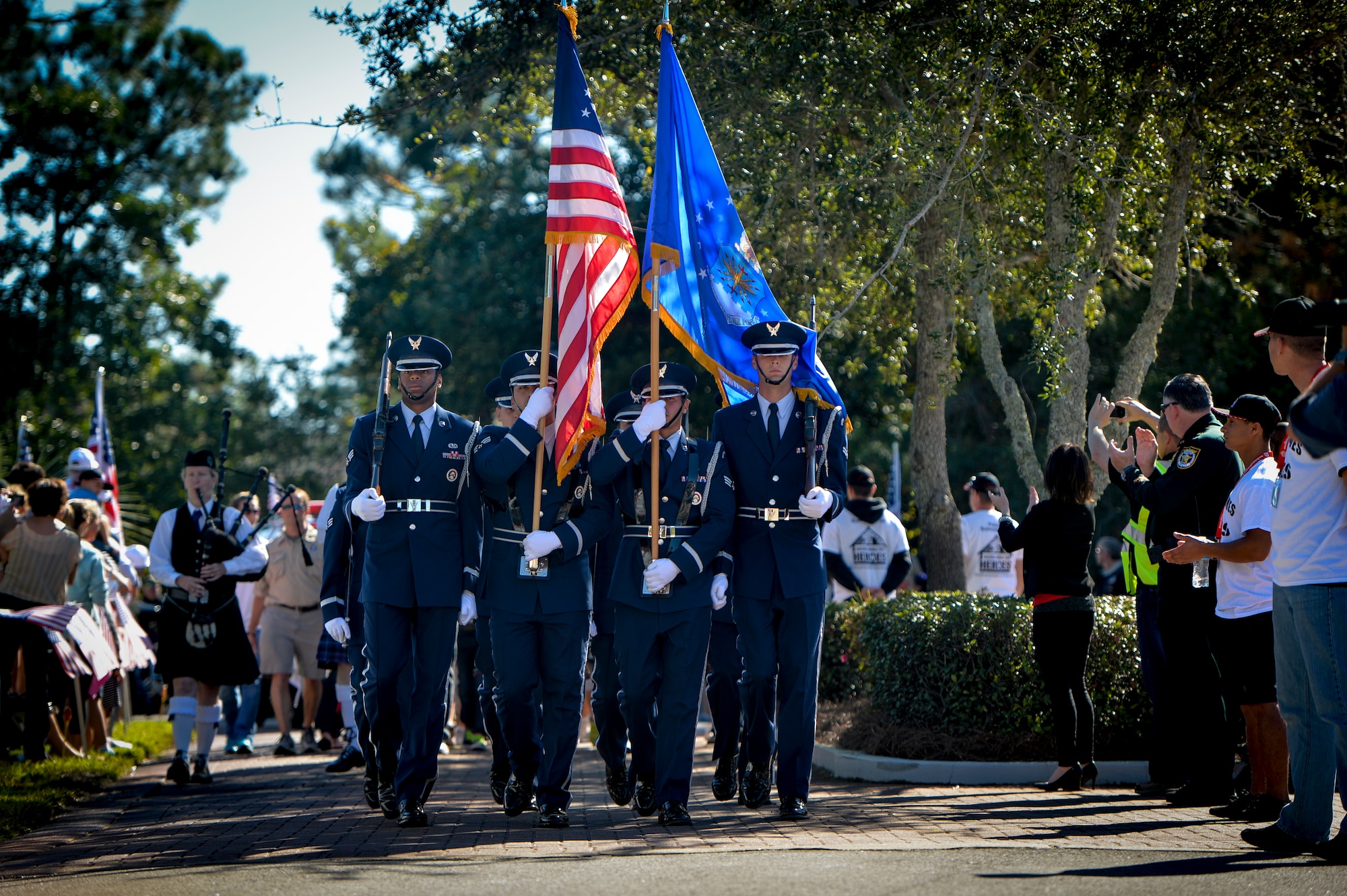 The Hurlburt Field honor guard leads a procession during a welcome home ceremony in Destin, Fla., Oct. 25, 2014. Building Homes for Heroes presented a brand-new mortgage-free home to retired Air Force Master Sgt. Joe Deslauriers and his family during the ceremony. (U.S. Air Force photo/Senior Airman Christopher Callaway)