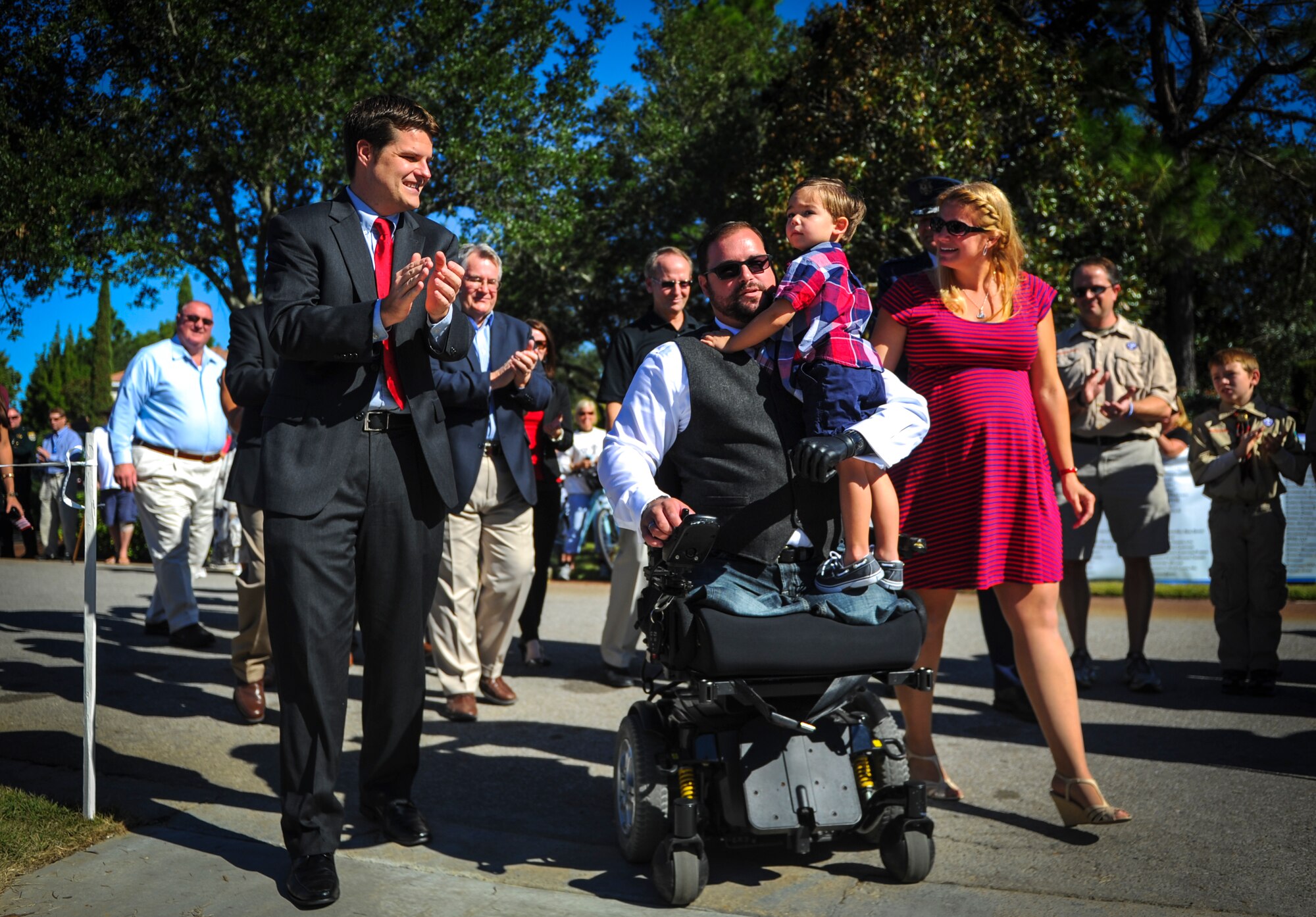 Joe Deslauriers, a retired Air Force Master Sgt., his wife Lisa and son Cameron arrive at a welcome home ceremony with Florida State Representative Matt Gaetz in Destin, Fla., Oct. 25, 2014. Building Homes for Heroes presented a brand-new mortgage-free home to Joe and his family during the ceremony. (U.S. Air Force photo/Senior Airman Christopher Callaway) 