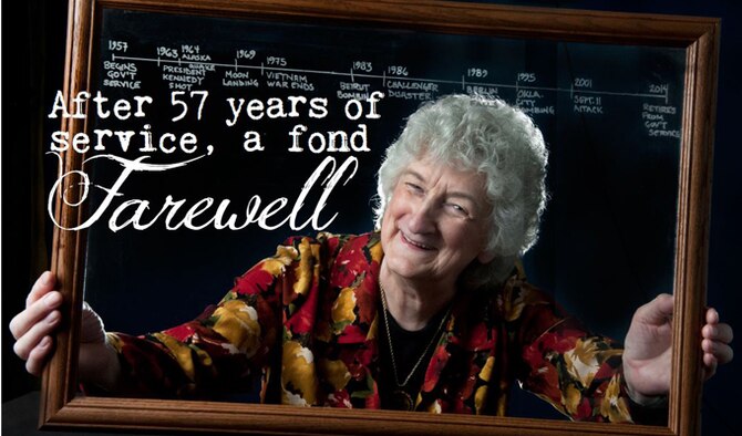 Ramona Moore poses at Joint Base Elmendorf-Richardson Oct. 15, 2014, with a timeline of major news events spanning her 57-year civil service with the Defense Department. Moore began her government career as a temporary supply clerk on Elmendorf Air Force Base in 1957 before transitioning into accounting and finance. Moore is an Air Force budget analyst. (U.S. Air Force photo/Justin Connaher)