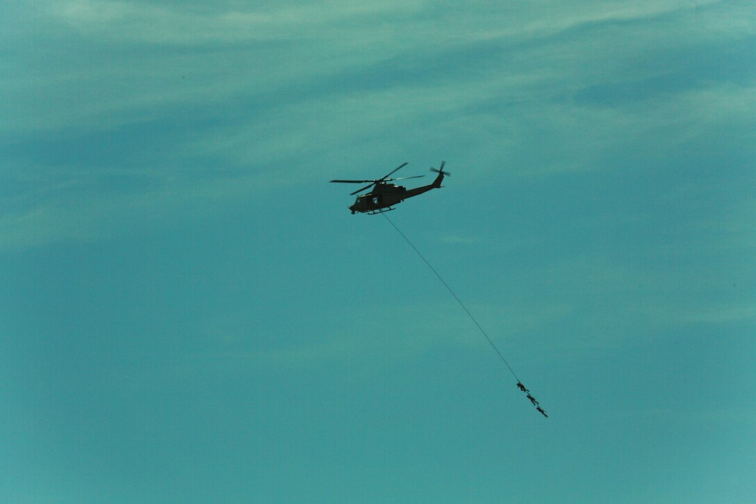 U.S. Marines with Battalion Landing Team, 3rd Battalion, 1st Marine Regiment, and various units practice special-patrol insertion and extraction rigging from a UH-1Y Huey aircraft during a helicopter rope-suspension techniques masters course aboard Camp Pendleton, Calif., Oct. 22, 2014. BLT 3/1 is scheduled to deploy as the ground combat element with the 15th Marine Expeditionary Unit next spring. (U.S. Marine Corps photo by Staff Sgt. Miguel Carrasco/Released)