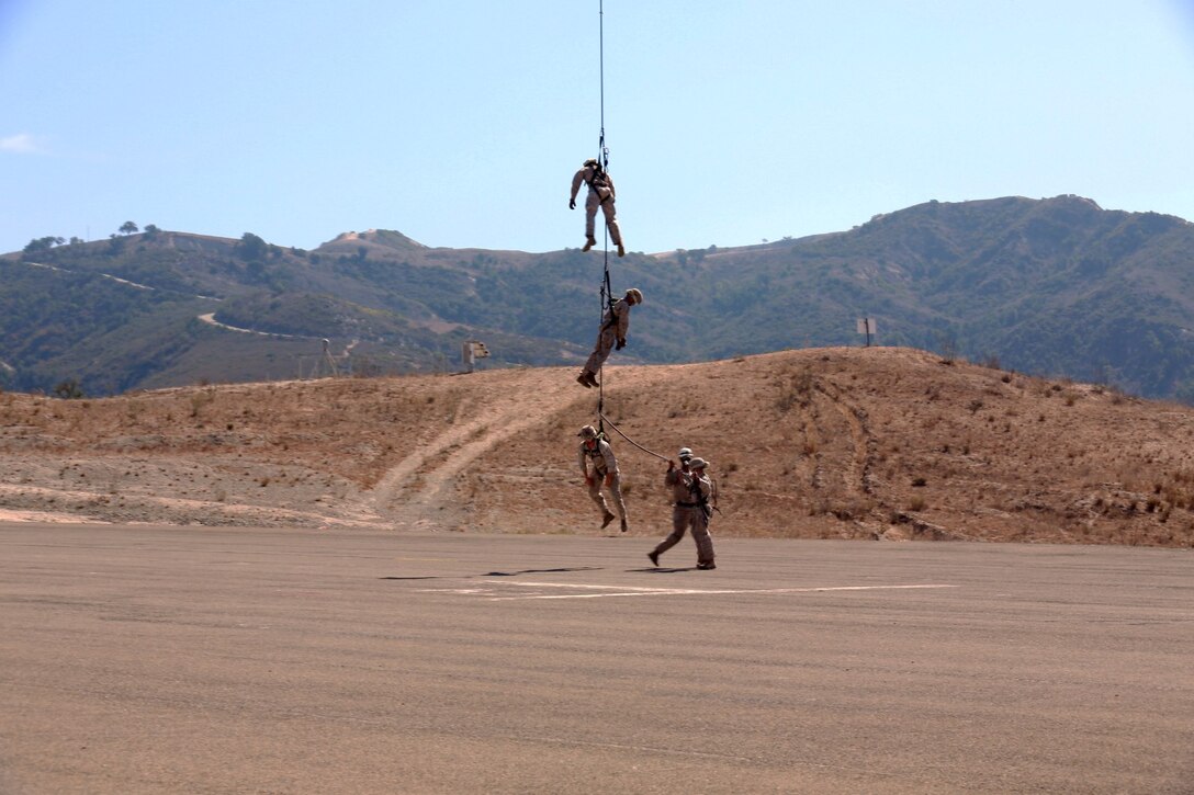 U.S. Marines with Battalion Landing Team, 3rd Battalion, 1st Marine Regiment, and various units practice special-patrol insertion and extraction rigging from a UH-1Y Huey aircraft during a helicopter rope-suspension techniques masters course aboard Camp Pendleton, Calif., Oct. 22, 2014. BLT 3/1 is scheduled to deploy as the ground combat element with the 15th Marine Expeditionary Unit next spring. (U.S. Marine Corps photo by Staff Sgt. Miguel Carrasco/Released)