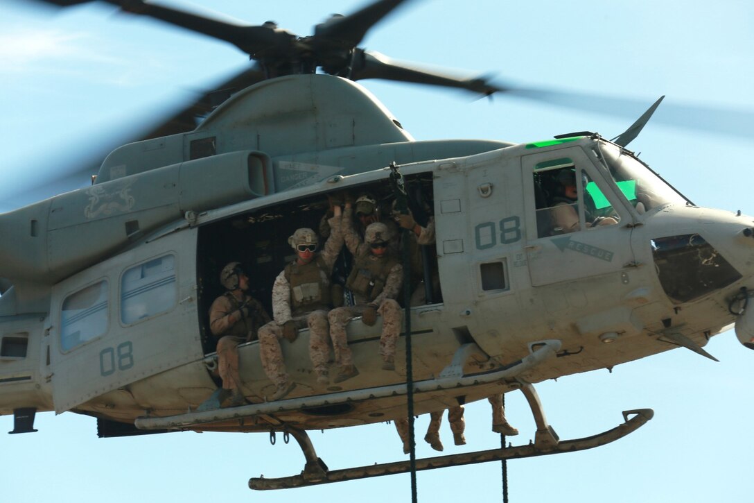 U.S. Marines with Battalion Landing Team, 3rd Battalion, 1st Marine Regiment, and various units prepare to fast rope from a UH-1Y Huey aircraft during a helicopter rope-suspension techniques masters course aboard Camp Pendleton, Calif., Oct. 22, 2014. BLT 3/1 is scheduled to deploy as the ground combat element with the 15th Marine Expeditionary Unit next spring. (U.S. Marine Corps photo by Staff Sgt. Miguel Carrasco/Released)