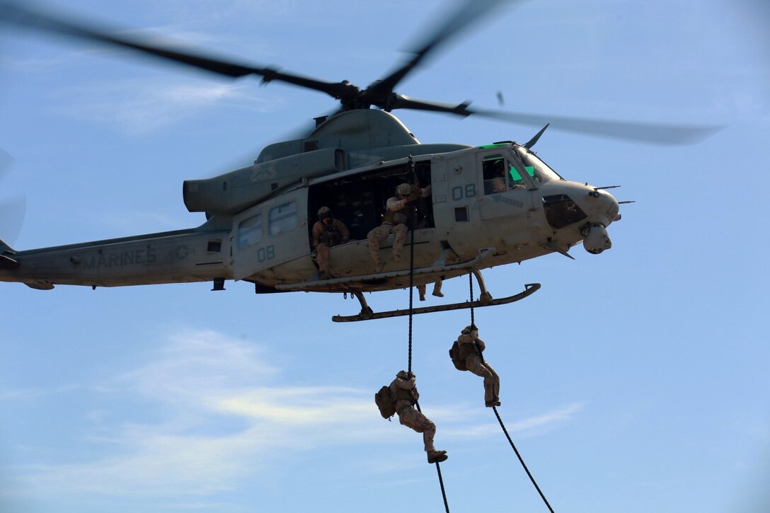 U.S. Marines with Battalion Landing Team, 3rd Battalion, 1st Marine Regiment, and various units practice fast roping from a UH-1Y Huey aircraft during a helicopter rope-suspension techniques masters course aboard Camp Pendleton, Calif., Oct. 22, 2014. BLT 3/1 is scheduled to deploy as the ground combat element with the 15th Marine Expeditionary Unit next spring. (U.S. Marine Corps photo by Staff Sgt. Miguel Carrasco/Released)
