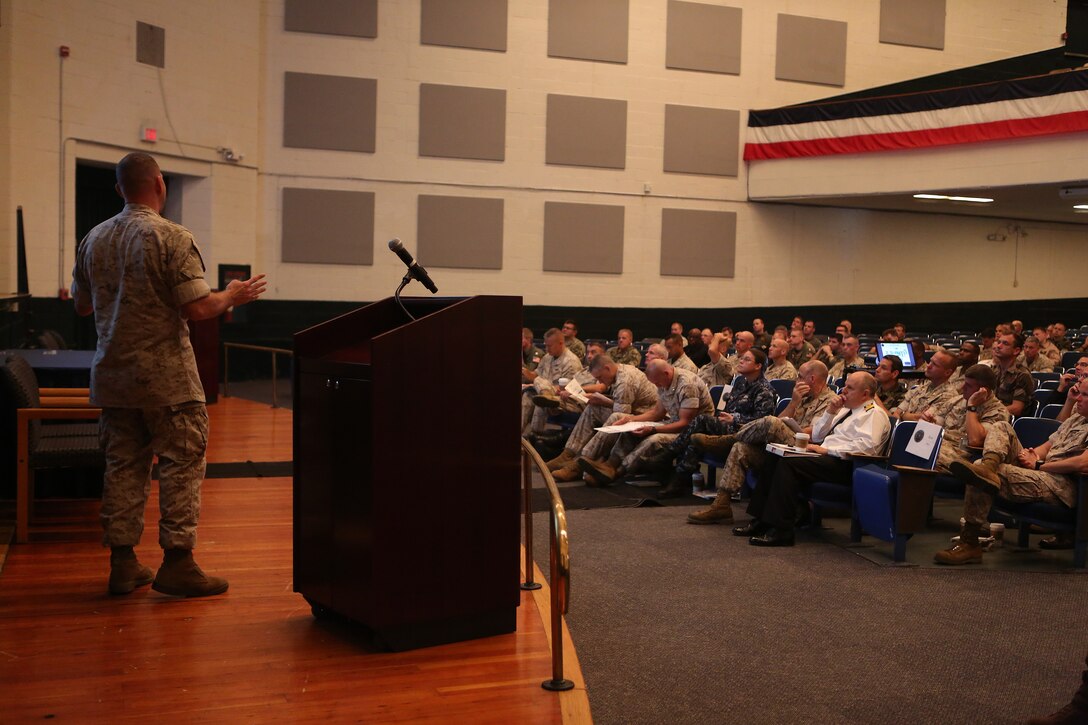 U.S. Marine Maj. Marcus J. Mainz, Future Operations planner with 2d Marine Expeditionary Brigade (MEB), speaks with Marines, sailors and Coalition forces assigned to 2d MEB at a transition brief in support of exercise Bold Alligator 14, at Naval Operations Base Norfolk, Va., Oct. 25, 2014. Exercise Bold Alligator 14 is a multi-national, synthetic naval amphibious exercise designed to train the full range of amphibious capabilities in order to provide unique and contemporary solutions to global challenges.