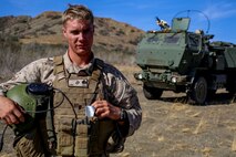 Sergeant Caleb Staats, a launcher chief with Battery Q, 5th Battalion, 11th Marine Regiment poses in front of an M142 High Mobility Artillery Rocket System during a live-fire training exercise aboard Marine Corps Base Camp Pendleton, Calif., October 22, 2014. Conducting live-fire exercises strengthens the Marines’ ability to fire effectively in future operations.