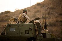 Sergeant John Matthieu, a High Mobility Artillery Rocket System operator with Battery Q, 5th Battalion, 11th Marine Regiment, supervises a rocket reload during a live-fire exercise aboard Marine Corps Base Camp Pendleton, Calif., Oct. 22, 2014. Conducting live-fire exercises strengthens the Marines’ ability to fire effectively in future operations.