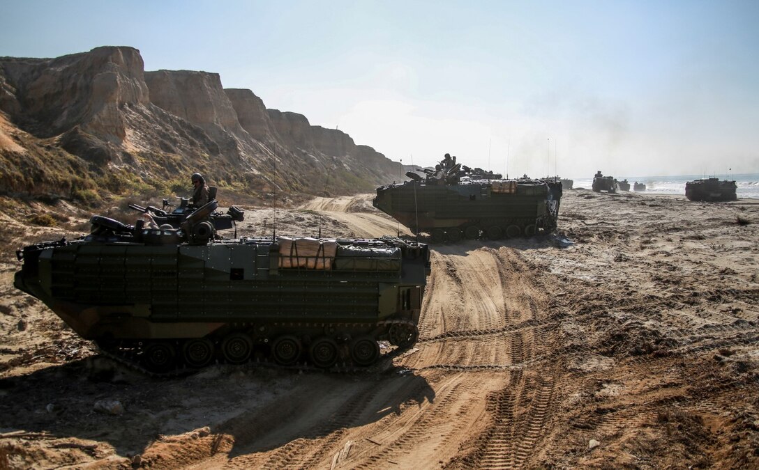 AAV-7A1 Amphibious Assault Vehicles with Battalion Landing Team, 3rd Battalion, 1st Marine Regiment, 15th Marine Expeditionary Unit assault a beach during a simulated mechanized raid aboard Camp Pendleton, Calif., Oct. 21, 2014. BLT 3/1 is the 15th MEU’s ground combat element. (U.S. Marine Corps photo by Cpl. Steve H. Lopez/Released)