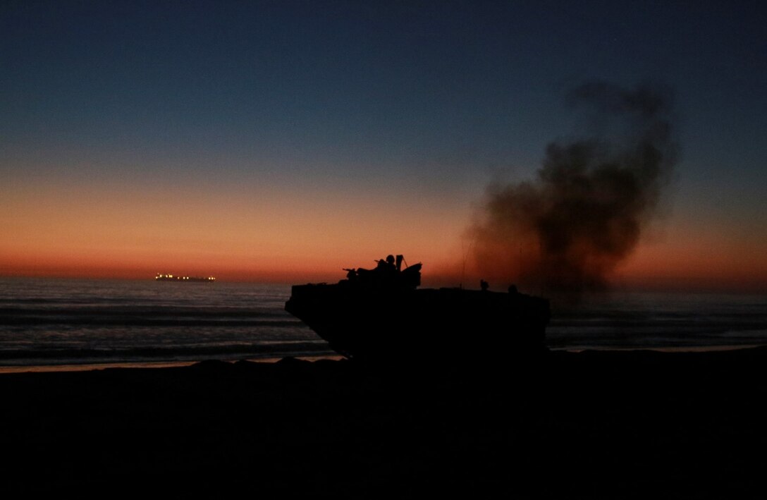 AAV-7A1 Amphibious Assault Vehicles with Kilo Company, Battalion Landing Team, 3rd Battalion, 1st Marine Regiment, 15th Marine Expeditionary Unit, hit the beach during a simulated mechanized night raid aboard Camp Pendleton, Calif., Oct. 23, 2014. BLT 3/1 is the 15th MEU’s ground combat element. (U.S. Marine Corps photo by Cpl. Steve H. Lopez/Released)
